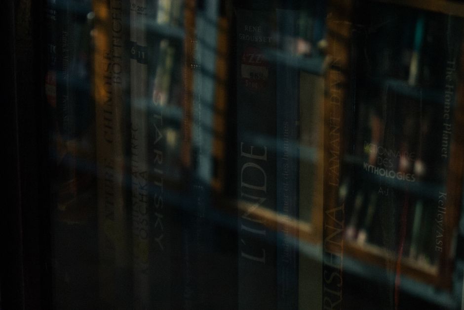 Top view of collection with famous novels with colorful inscriptions and covers arranged on white marble surface