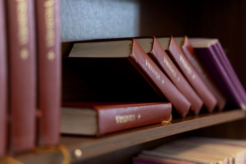 Close-up of hymn books on a shelf with selective focus highlighting the textures.